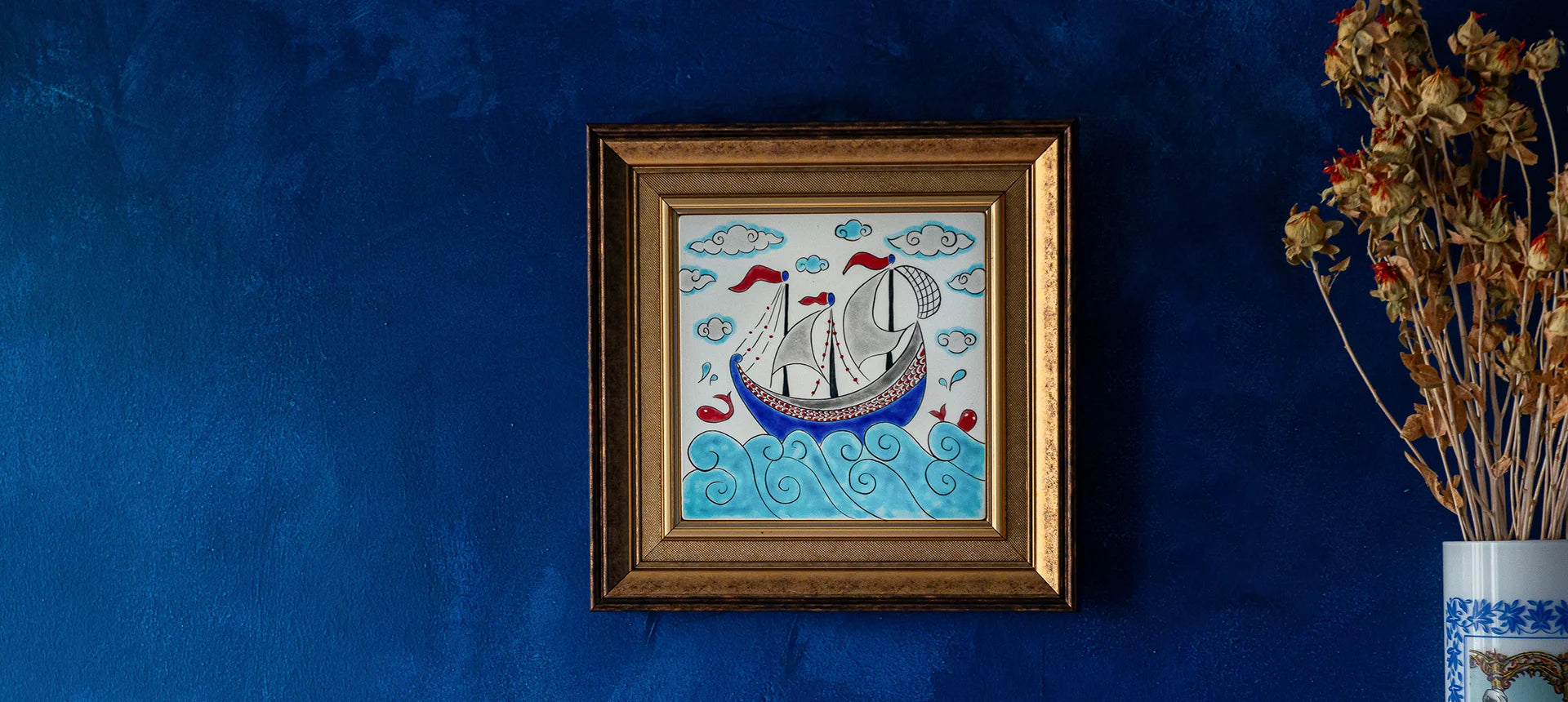Turkish ceramic hanged on the blue background wall with sailing ship design