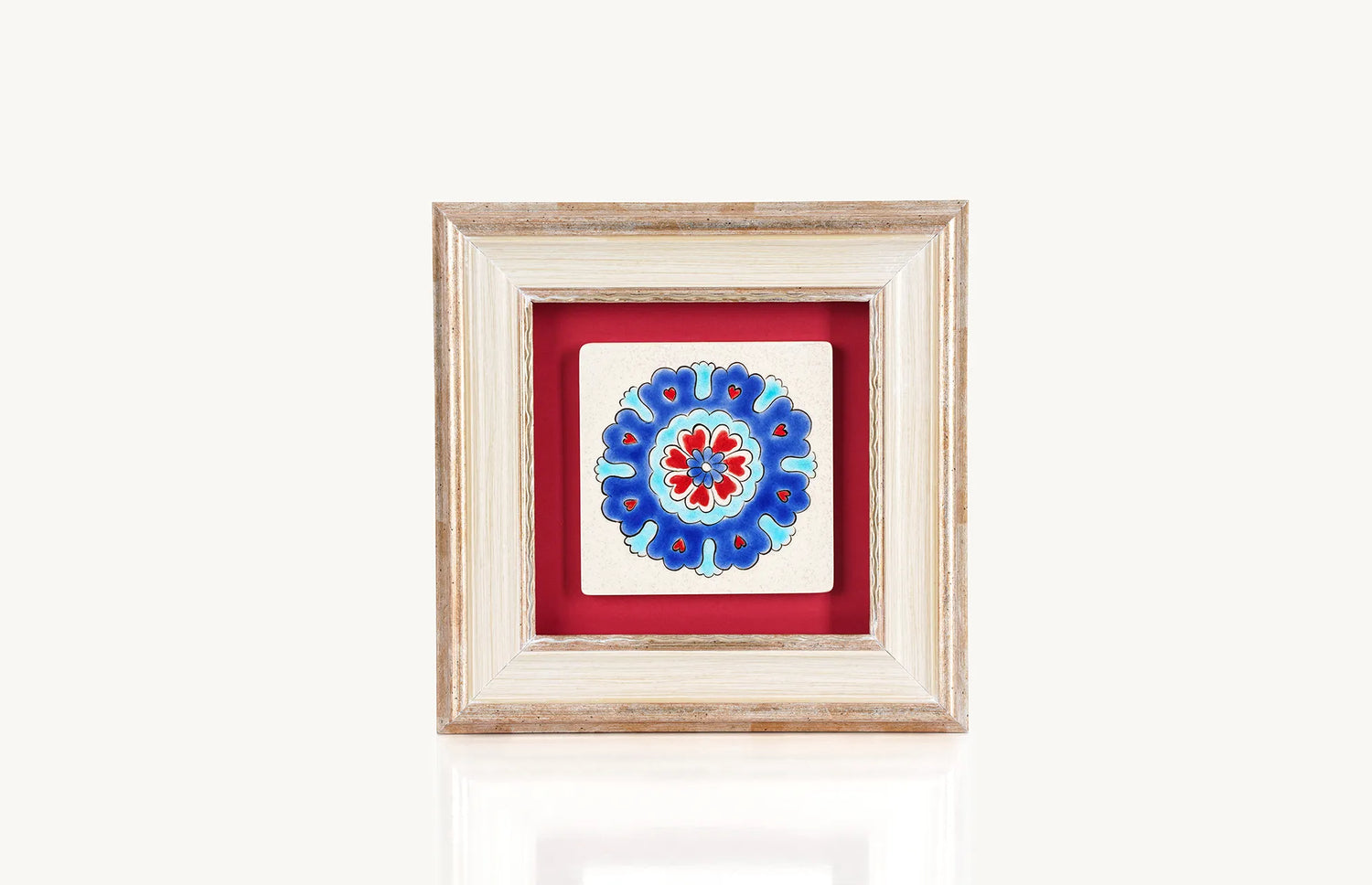 Petal motifs with heart painted on ceramic in blue, red and turquoise colors