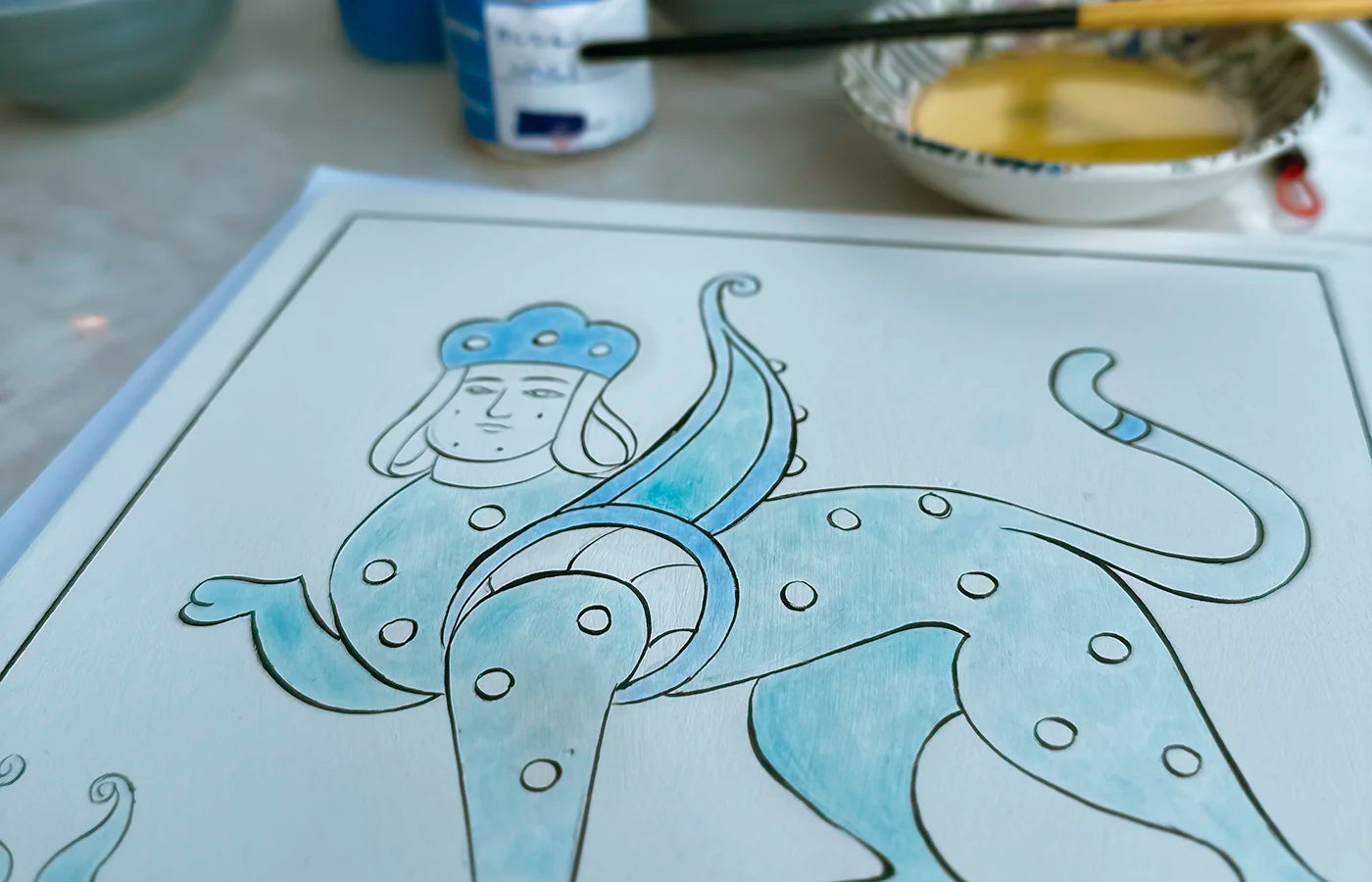 Sphinx painted on square ceramic in blue and shades of turquoise